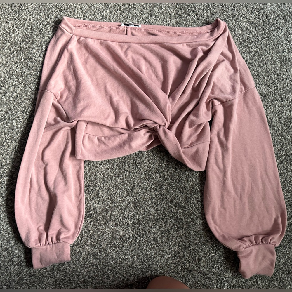 Woman’s pink off the shoulder shirt